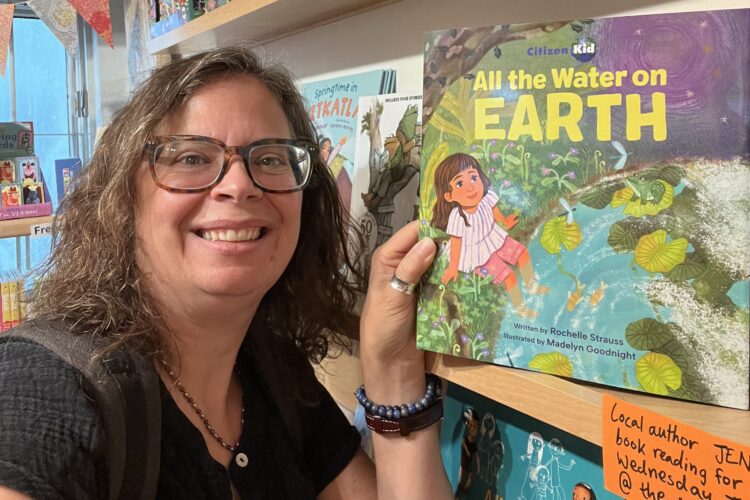 Author Rochelle Strauss stands next to her new children's book, All the Water on Earth
