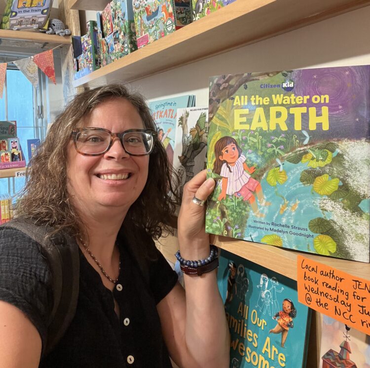 Author Rochelle Strauss stands next to her new children's book, All the Water on Earth